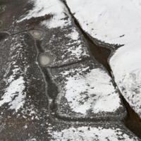 Crushed marble dust in cracks of rocks.