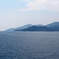 View of the southeastern side of the island where  forests and quarries are visible.